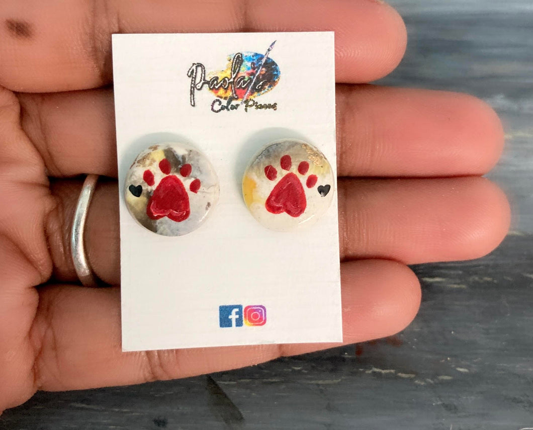 White earring studs with cat/dog footprint.