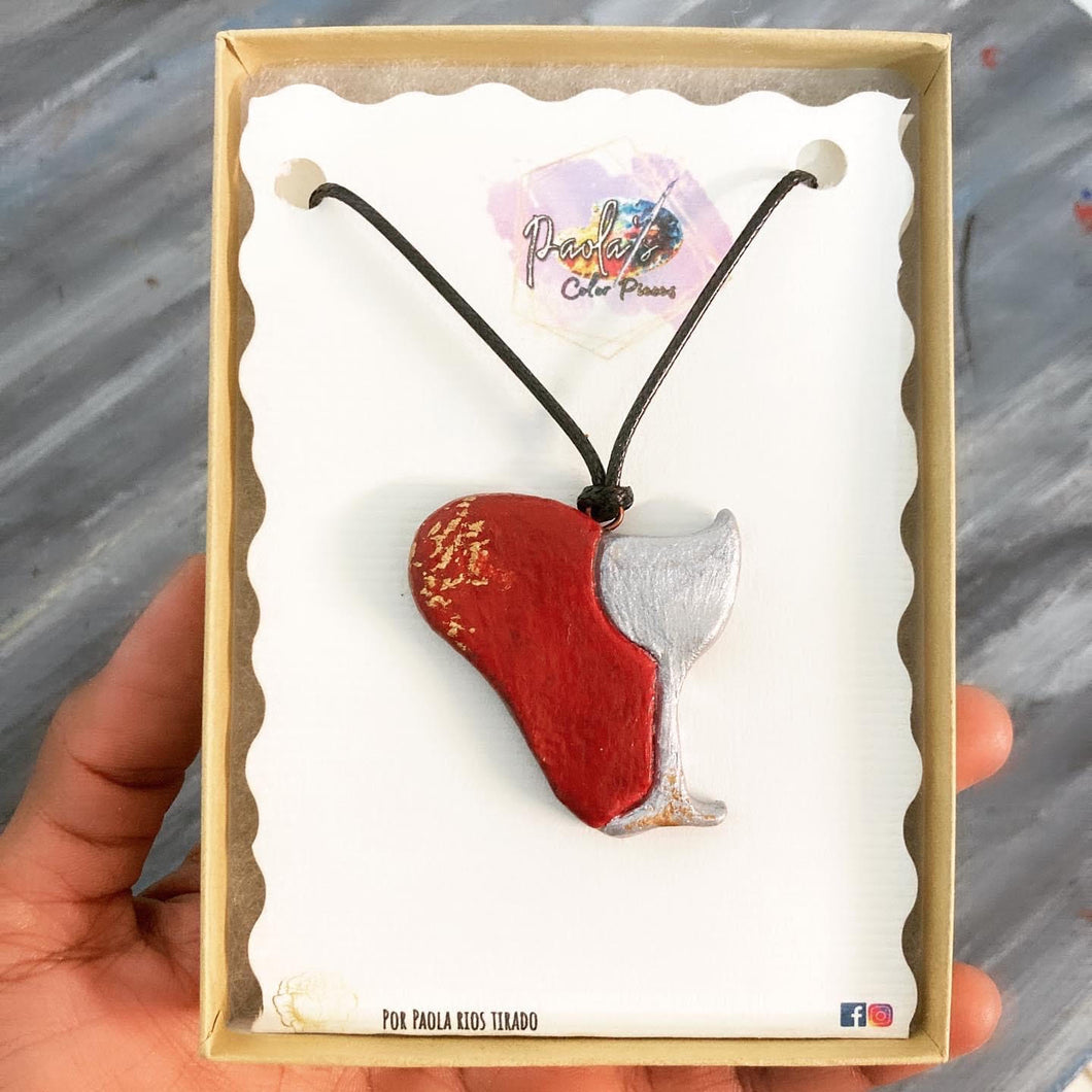 Wine glass and heart shaped necklace.